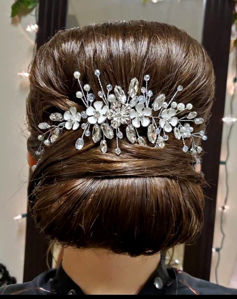 a bride's hair with a hair piece placed in the back