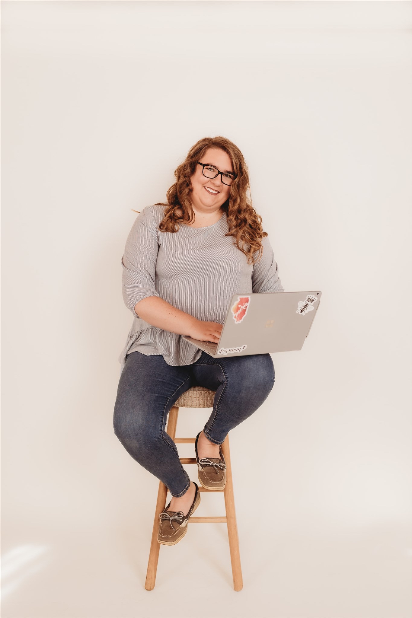 Hannah setting on a chair with a computer