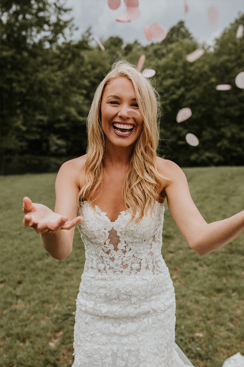 a model in a wedding dress holding out her hands