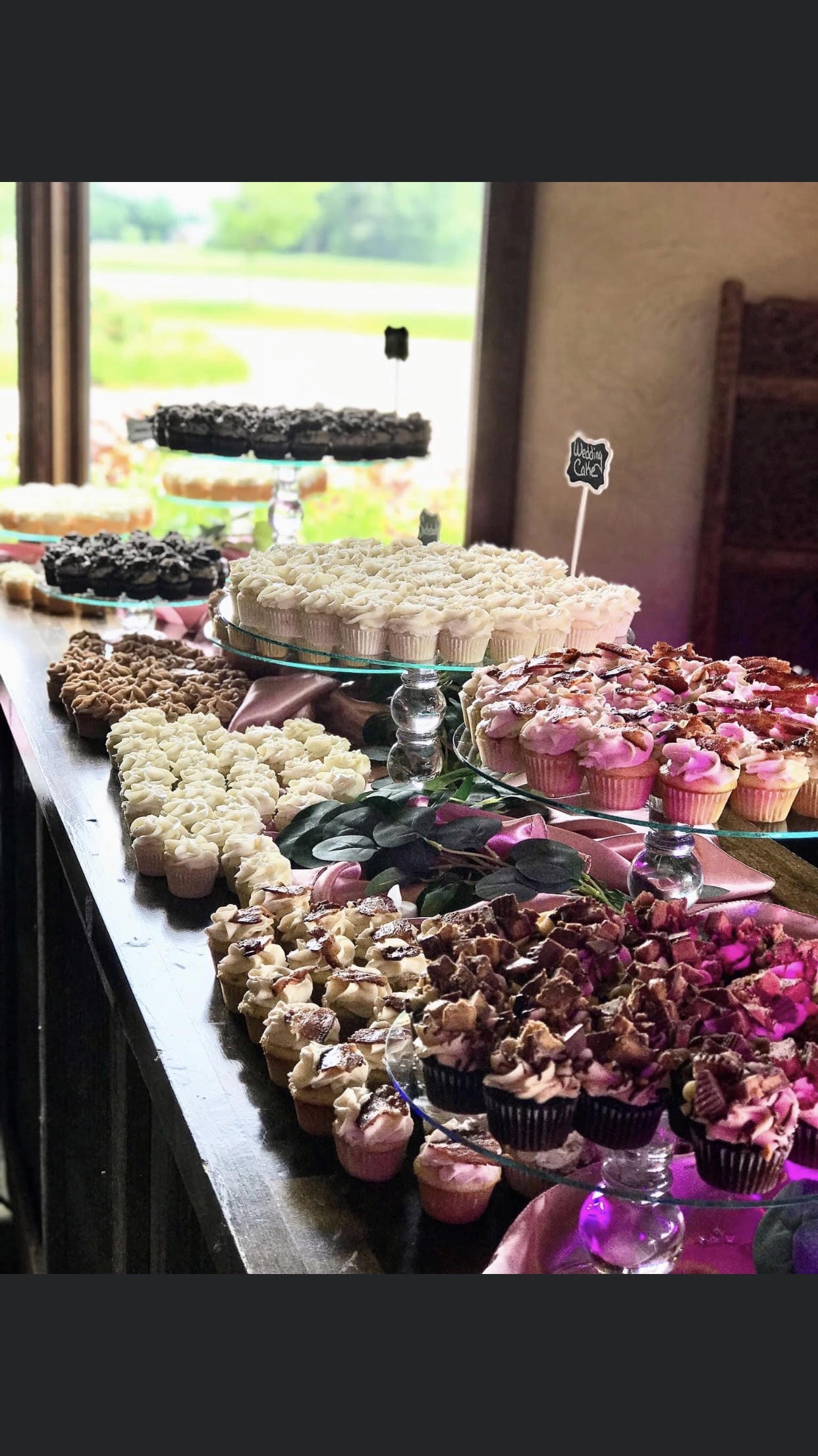 cup cakes placed on cake stands on a table