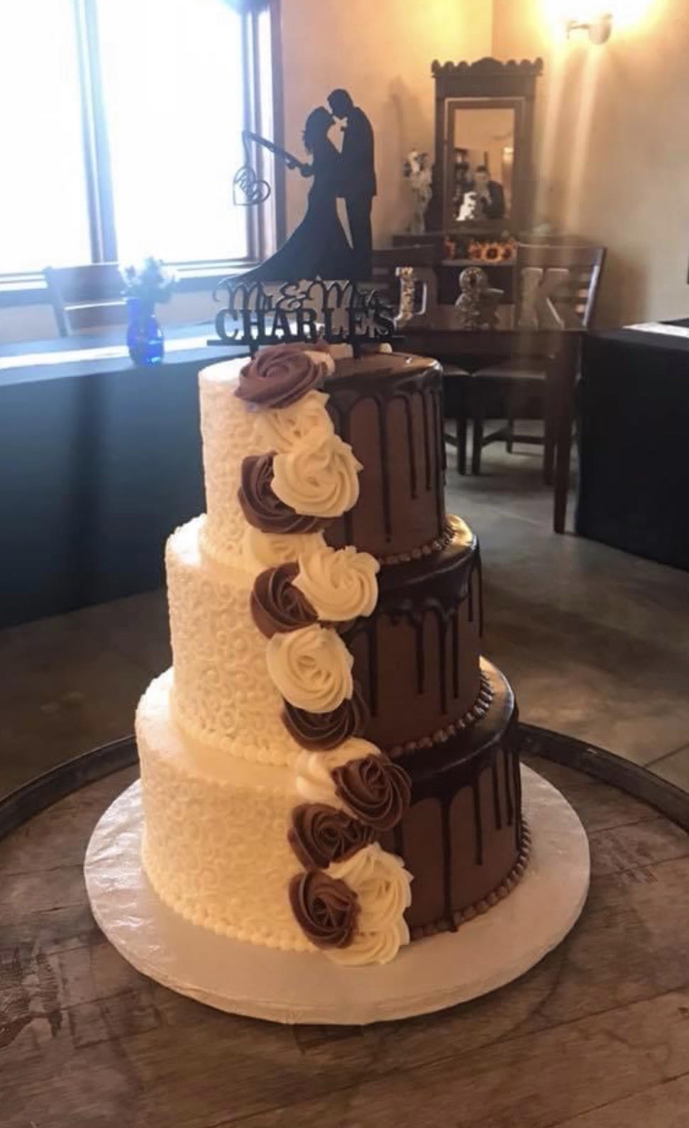 a white and chocolate cake with a decorative top