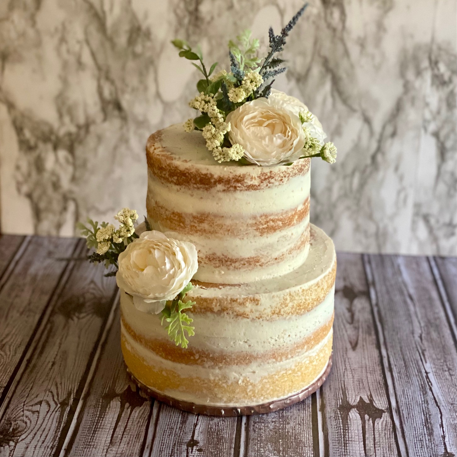 a wedding cake with floral style decorations on top