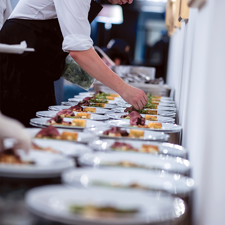 caterer setting out food at a wedding