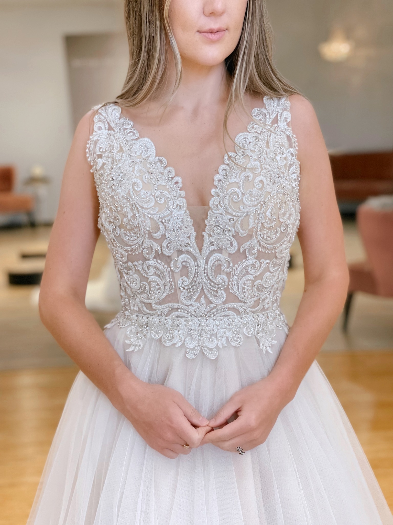 bride in her wedding dress holding her hands together