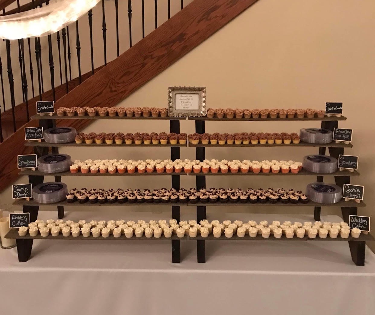 cup cakes placed on shelving on a table