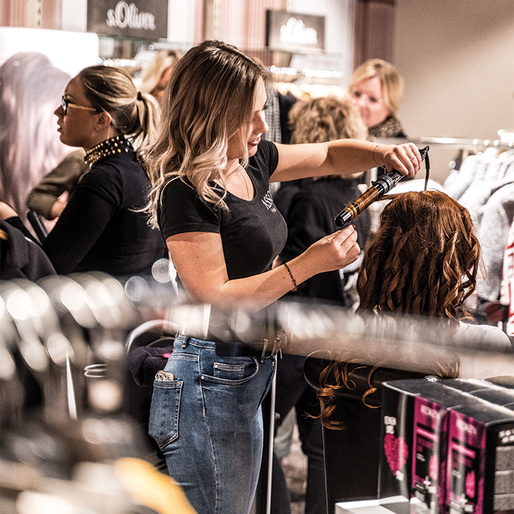 hair stylist working on a client's hair